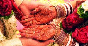 Close up of the groom and bride holding hands